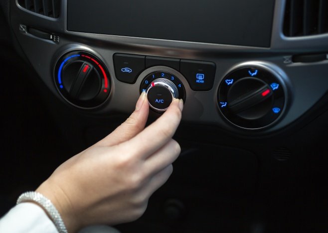 Woman,Turning,On,Car,Air,Conditioning,System
